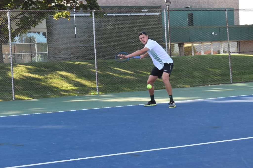 David Solar hitting on an outdoor hard court